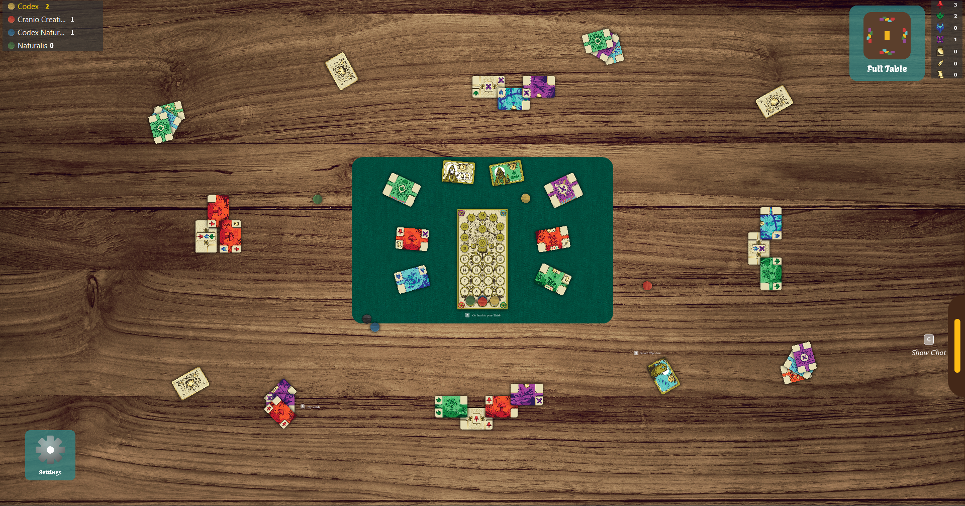 The JavaFX graphical client: a wooden table seen from above with players' cards, the scoring board and a minimap